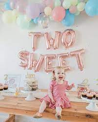 Toddler smiling at a "Two Sweet" Event